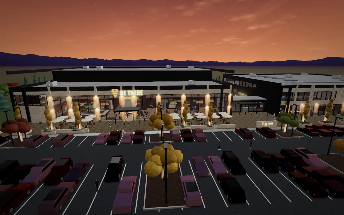 Aerial view of the BeThere Campus at sunset: the watch-party hall and sports building behind a full parking lot