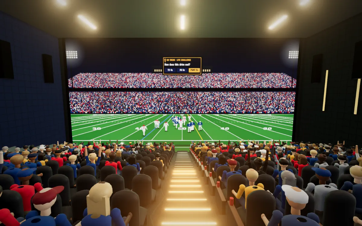 Theater 1 from the top row: sixteen rows of stadium seating facing a 94-foot wall with a football game and a BeThere live Challenge